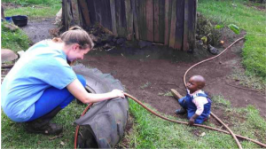 Julia playing with a child on a farm