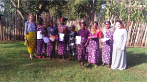 Michaela, Mireyne, and I posing for a photo with champs from Joy women’s group after presenting them with certificates of appreciation and lessos, a fabric used as a skirt or apron.
