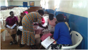 Mary, the Upendo chairwoman, helps the group plan what they will prepare for the Upendo Women's Group training session